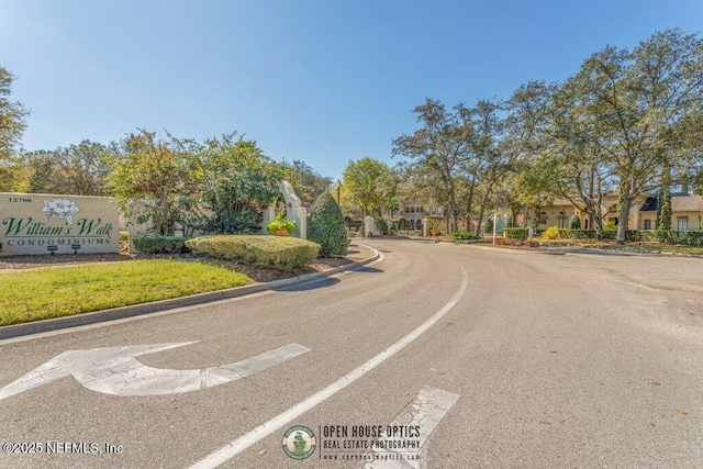 view of road featuring a residential view and curbs