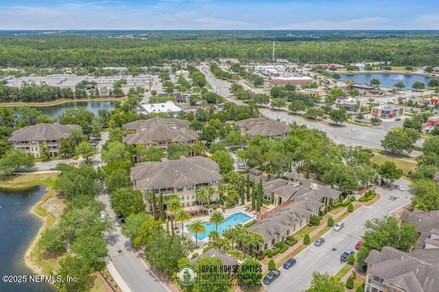 drone / aerial view featuring a water view and a residential view