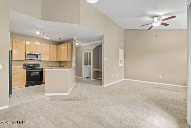 kitchen featuring light brown cabinets, light colored carpet, open floor plan, light countertops, and black appliances