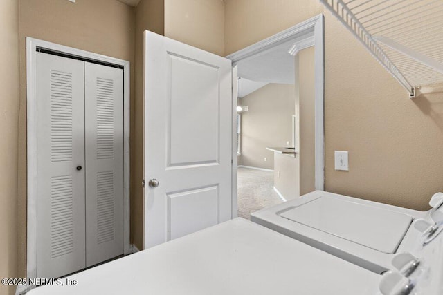 carpeted bedroom with a closet and washing machine and clothes dryer