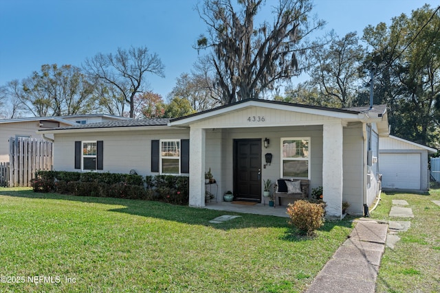 ranch-style home featuring a garage, fence, a porch, and a front yard