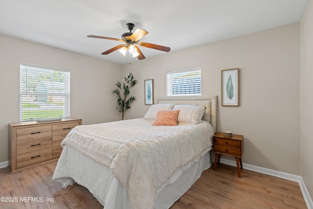 bedroom featuring light wood-style floors, ceiling fan, and baseboards