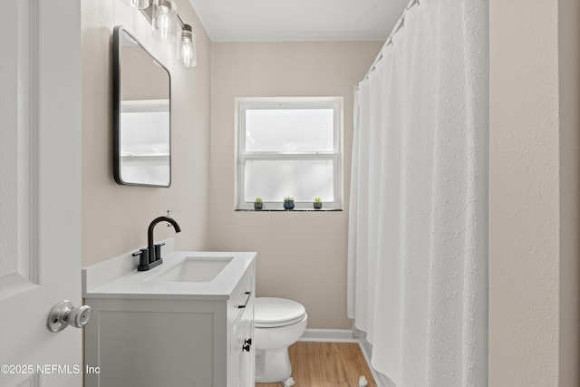 full bathroom featuring baseboards, vanity, toilet, and wood finished floors