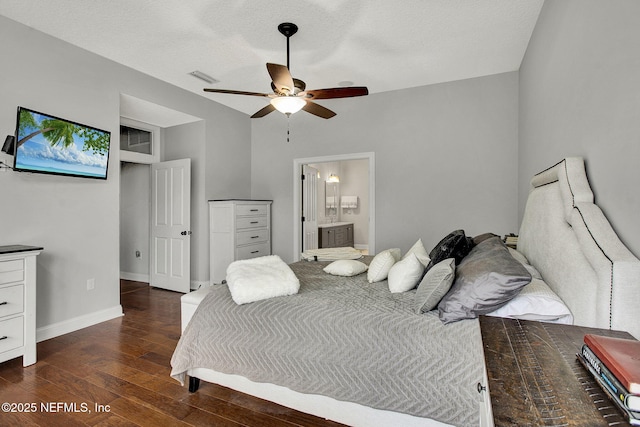 bedroom featuring dark wood-style flooring, visible vents, connected bathroom, and baseboards