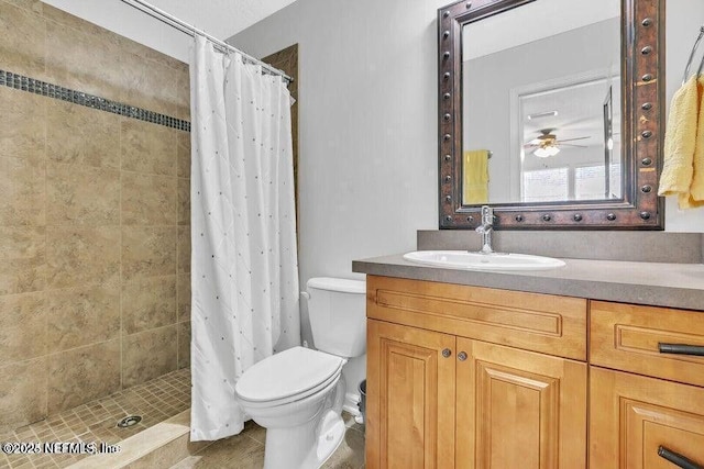 full bathroom with vanity, a shower stall, and toilet