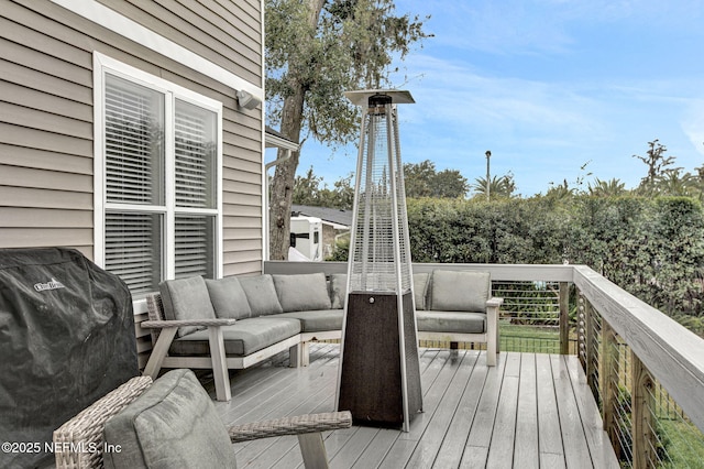 wooden terrace with an outdoor living space