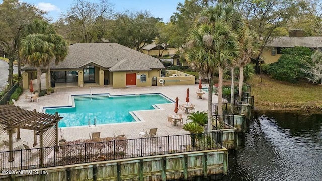 community pool featuring a patio, a water view, fence, and a pergola