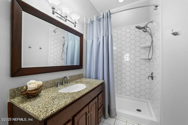 full bathroom featuring ornamental molding, a stall shower, tile patterned flooring, and vanity