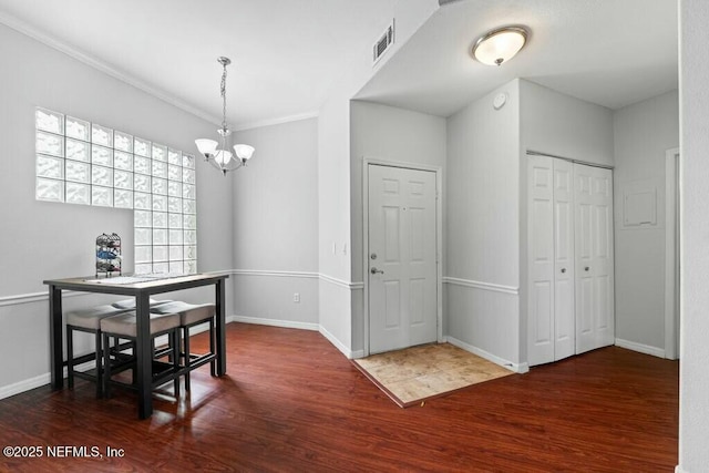 dining space with an inviting chandelier, baseboards, visible vents, and dark wood finished floors