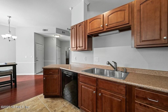 kitchen featuring pendant lighting, brown cabinets, visible vents, a sink, and dishwasher