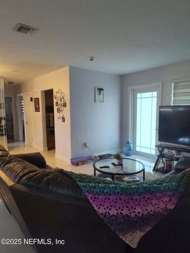 living room featuring visible vents and baseboards