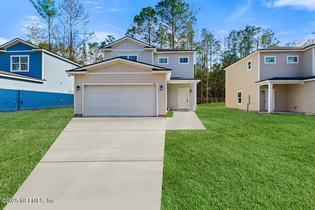 view of front facade with driveway, an attached garage, and a front yard