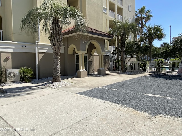 exterior space featuring ac unit and fence