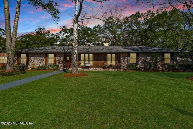 mid-century home featuring a yard