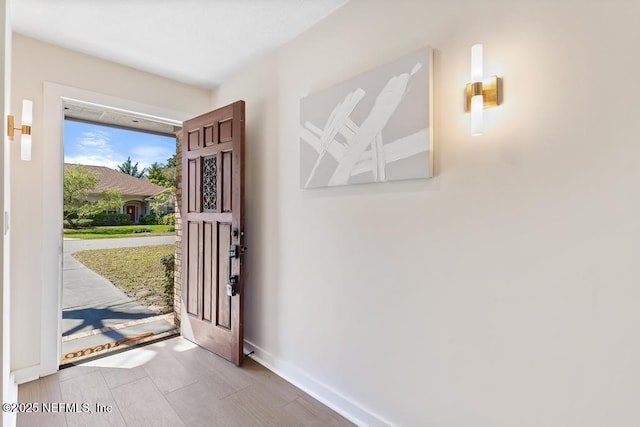 foyer featuring baseboards