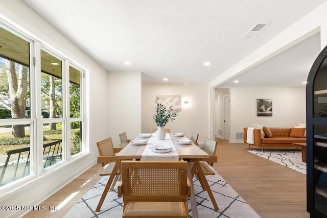 dining room featuring light wood-style flooring, visible vents, baseboards, and recessed lighting