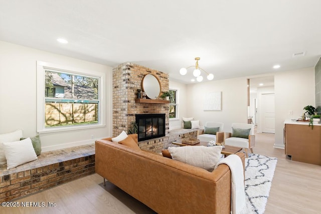 living area featuring a fireplace, recessed lighting, visible vents, light wood-style floors, and baseboards