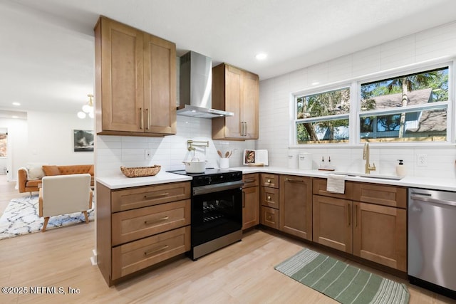 kitchen with light countertops, a sink, wall chimney range hood, black range with electric cooktop, and dishwasher