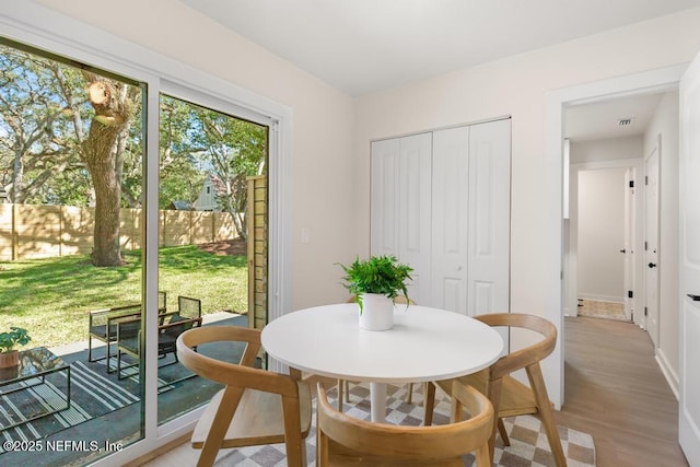 dining space with light wood-style flooring