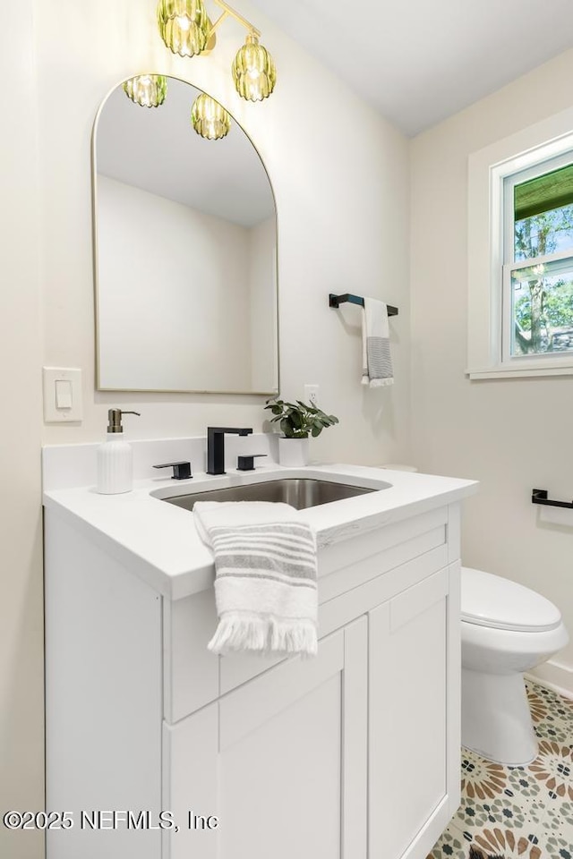 bathroom with vanity and toilet