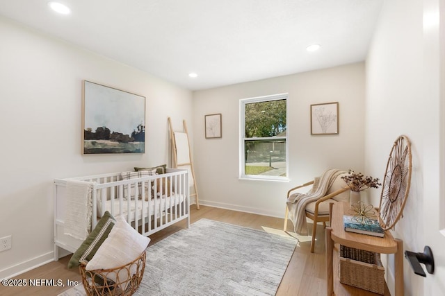 bedroom with recessed lighting, baseboards, and wood finished floors