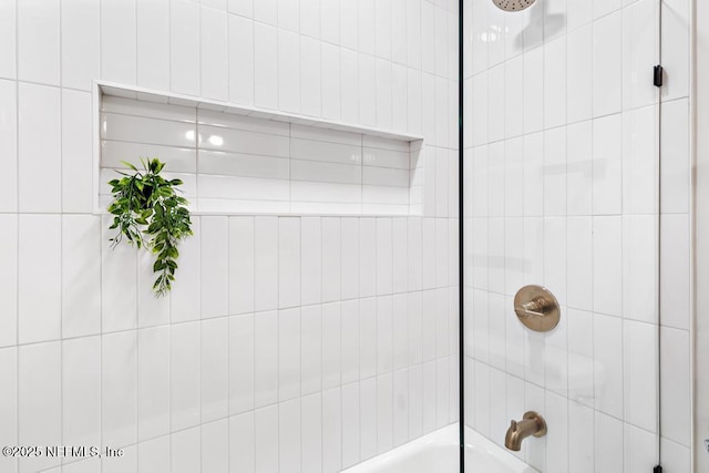 room details featuring shower / bath combination