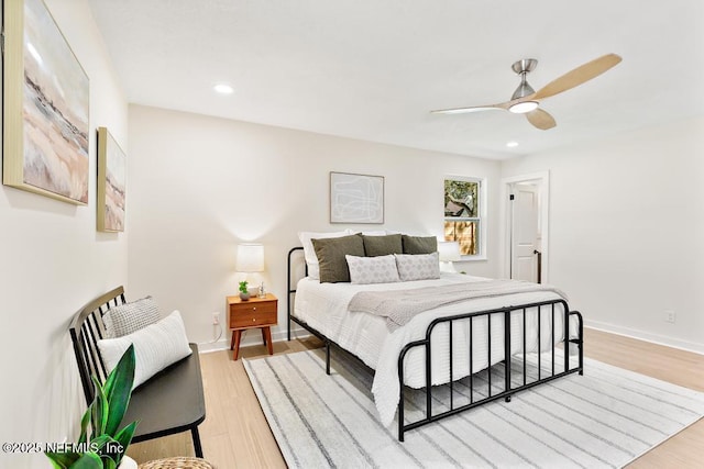 bedroom featuring light wood-type flooring, ceiling fan, baseboards, and recessed lighting