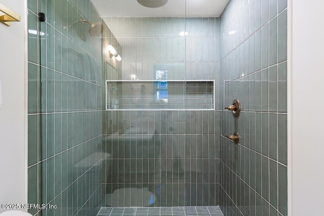 bathroom with tiled shower