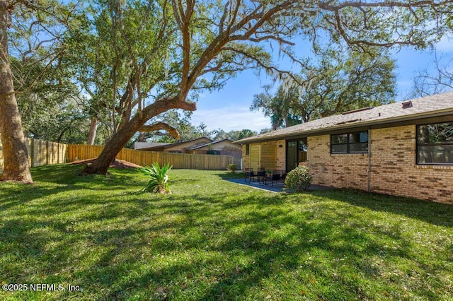 view of yard with a fenced backyard and a patio