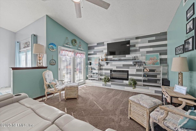 living room with lofted ceiling, an accent wall, plenty of natural light, and a large fireplace