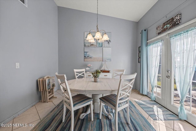 dining room featuring lofted ceiling, light tile patterned flooring, a notable chandelier, visible vents, and french doors