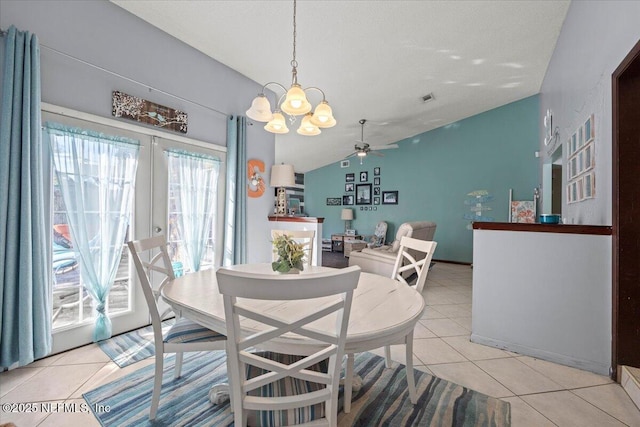 dining space with lofted ceiling, light tile patterned floors, visible vents, and french doors