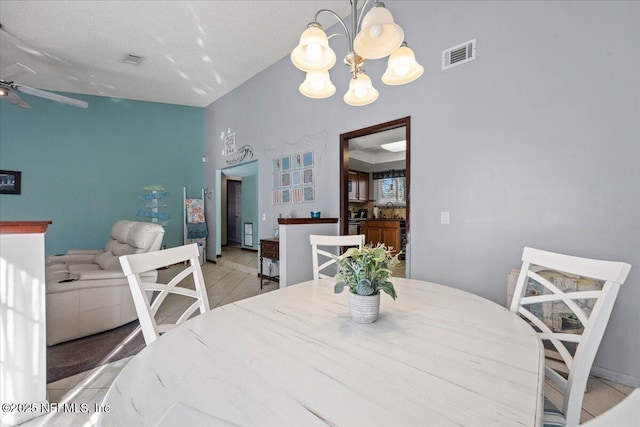 dining space with light tile patterned floors, visible vents, and ceiling fan with notable chandelier