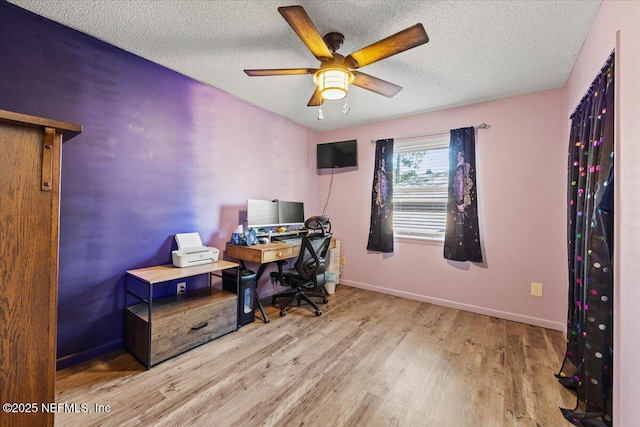 office with a textured ceiling, wood finished floors, a ceiling fan, and baseboards