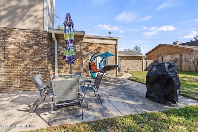 view of patio with outdoor dining area and fence