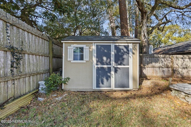 view of shed with a fenced backyard