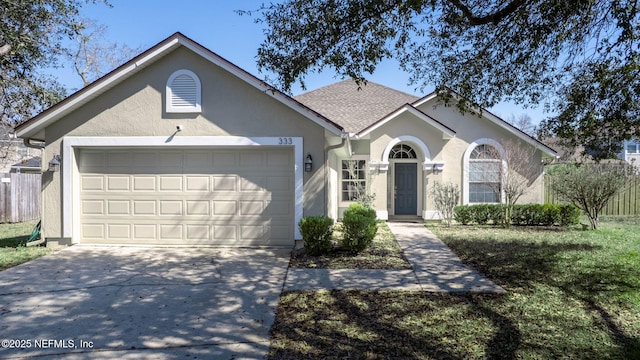 ranch-style home with driveway, an attached garage, and stucco siding