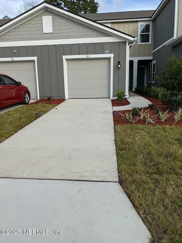 view of front of home featuring an attached garage, board and batten siding, and concrete driveway