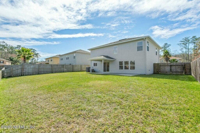 rear view of property with central AC unit, a lawn, a fenced backyard, and stucco siding