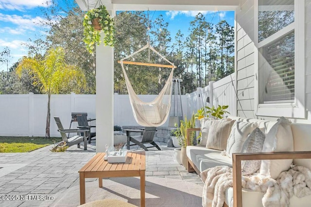 view of patio featuring outdoor lounge area and a fenced backyard