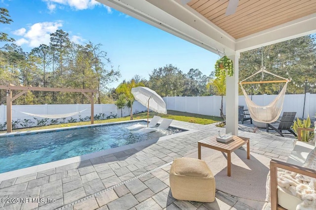 view of swimming pool featuring a patio area, a fenced backyard, and a fenced in pool