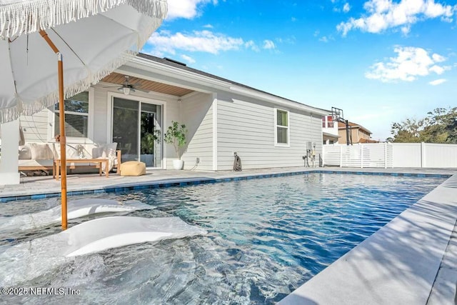 view of swimming pool featuring a fenced in pool, fence, a patio, and ceiling fan