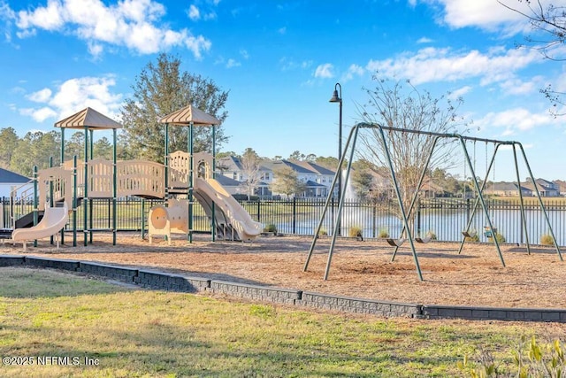 community play area featuring fence and a yard