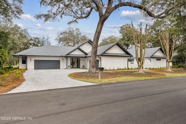 view of front of house featuring a garage and decorative driveway