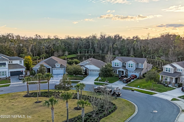 aerial view at dusk featuring a residential view