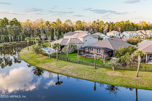 drone / aerial view featuring a water view and a residential view