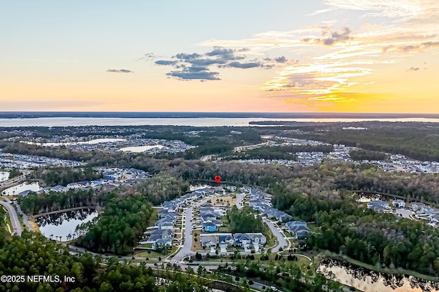 aerial view at dusk with a water view