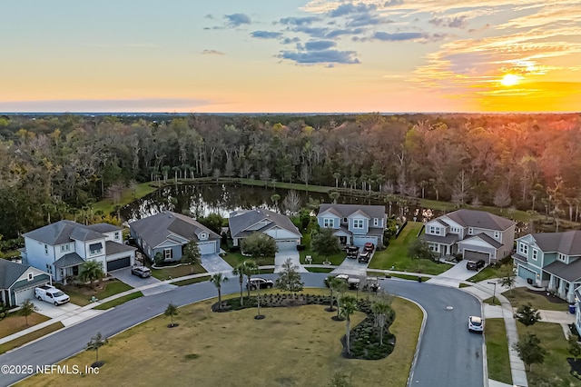 drone / aerial view featuring a forest view and a residential view