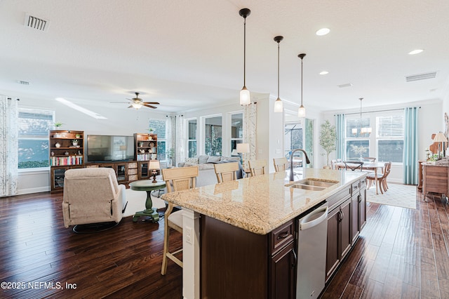 kitchen with dark wood finished floors, visible vents, a sink, dark brown cabinets, and dishwasher