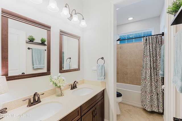 bathroom with shower / tub combo, a sink, toilet, and double vanity